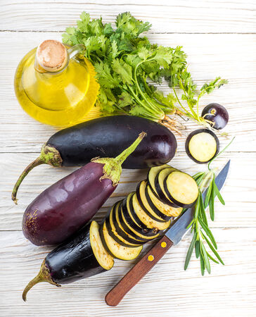 Eggplant and olive oil on a wooden boardの写真素材