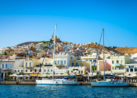 Greek island with colorful houses and yachts.の写真素材