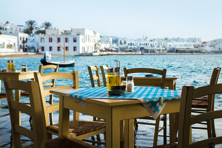 Greek island restaurants with colorful tables and chairs.の写真素材