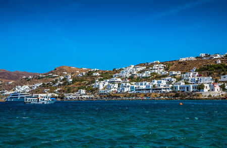 Greek island with colorful houses and yachts.の写真素材