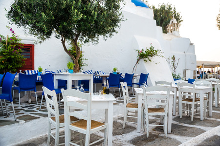 Greek island restaurants with colorful tables and chairs.の写真素材