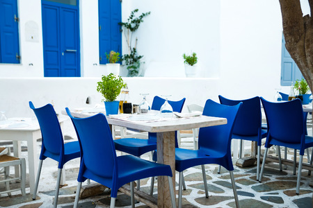 Greek island restaurants with colorful tables and chairs.の写真素材