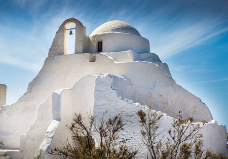 Churches and crosses on the Greek island in the sunsetの写真素材
