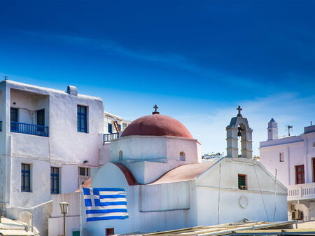 Churches and crosses on the Greek island in the sunsetの写真素材