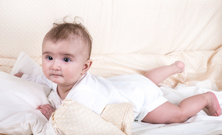 Child playing in a bed and does not want to sleep