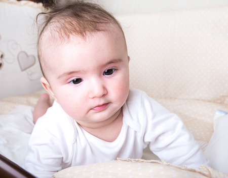Child playing in a bed and does not want to sleepの写真素材