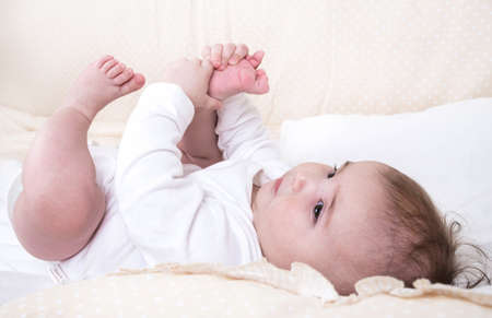 Child playing in a bed and does not want to sleep