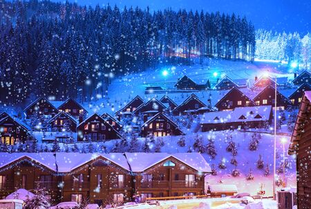 A fairy-tale house in the woods amid the snow-covered fir trees, Christmas landscape. Winter nature.の写真素材