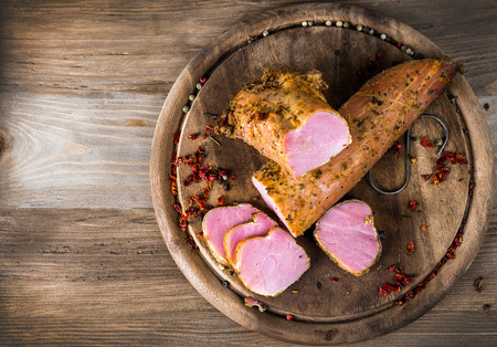 Smoked pork meat on a wooden backgroundの写真素材