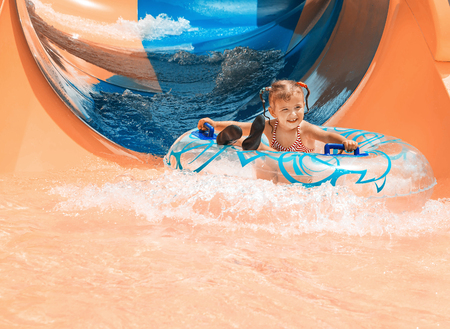Dad teaches a little daughter to swim in the pool. Aquapark.