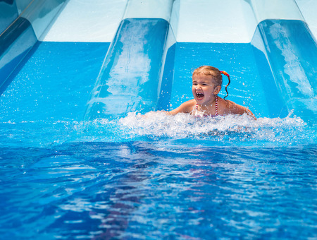 Dad teaches a little daughter to swim in the pool. Aquapark.
