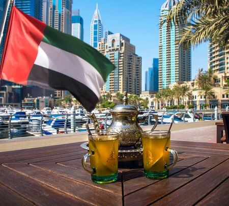 Tea in traditional oriental cups. Panoramic view of Dubai, UAE.の写真素材