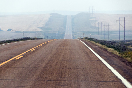 A hazy, hilly road in North Dakota.の写真素材