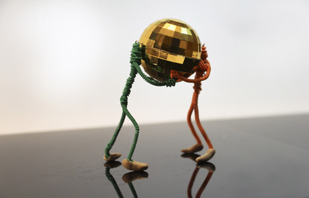 little people hold golden globeの写真素材