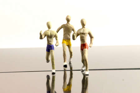 three runners in colour shorts on white backgroundの写真素材