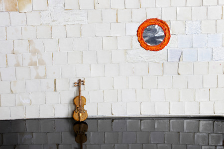 violin on white tile wallの写真素材