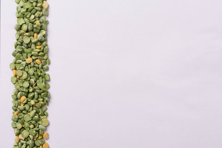 Peas line on left side of white paper background