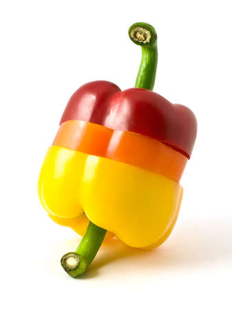 sliced three-color pepper isolated on white backgroundの写真素材