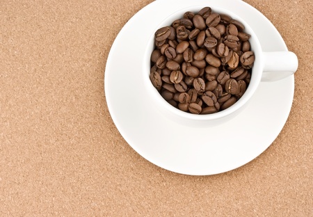 Coffee cup filled with coffee beansの写真素材