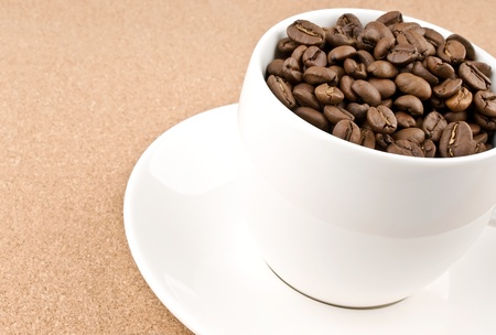 Close coffee cup filled with coffee beansの写真素材