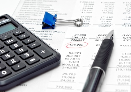 Financial report with calculator and penの写真素材