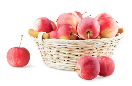 Overfull backet with mini apples isolated on white backgroundの写真素材