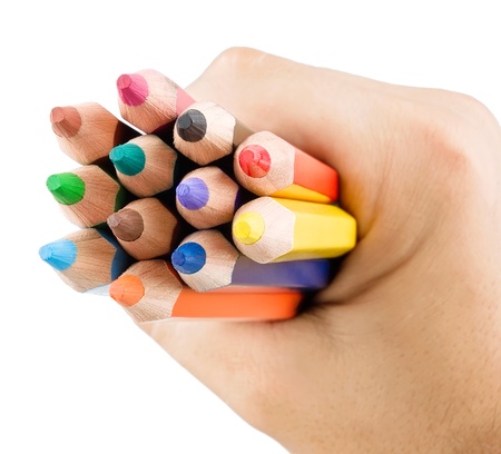 Multicolor pencils in hand isolated on white backgroundの写真素材