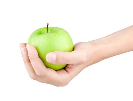 Green apple in female hand on white backgroundの写真素材