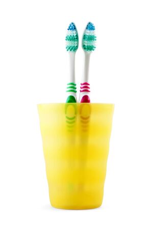 Two toothbrushes in jar on white backgroundの写真素材