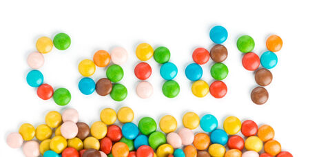 Candy word made of colorful candies on white の写真素材