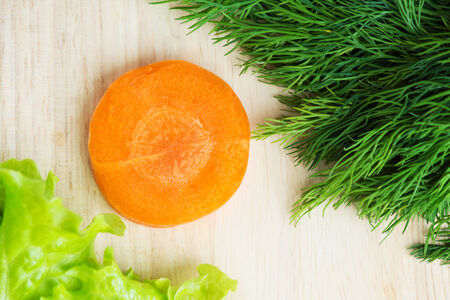 Healthy natural food. Carrot slice on tableの写真素材