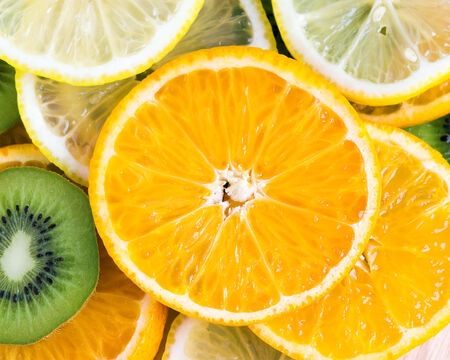 Collection of fruits slices. Orange, lemon and kiwi closeup. Healthy food background