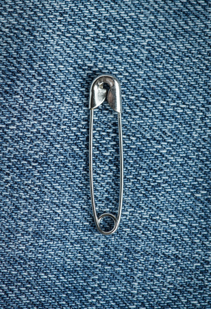 Safety pin on blue background closeupの写真素材
