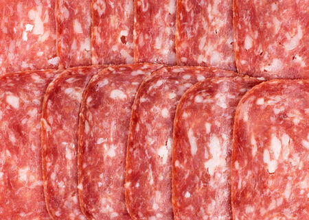 Salami slices closeup backgroundの写真素材