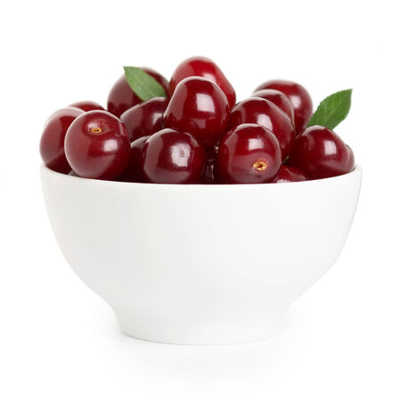 Sweet ripe cherry in bowl on white backgroundの写真素材