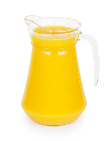 Fresh orange juice in pitcher on white backgroundの写真素材
