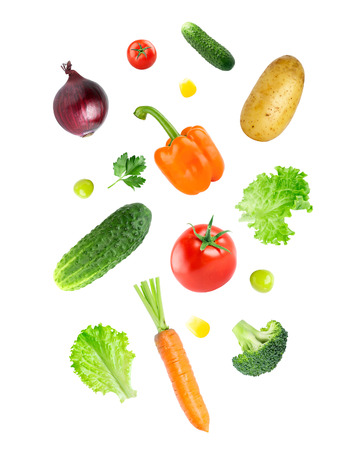 Falling fresh vegetables on white backgroundの写真素材