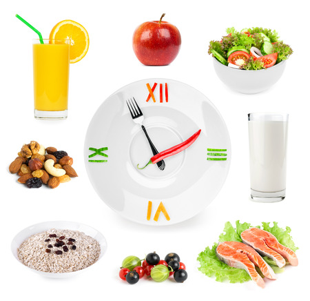 Clock with healthy diet food. Diet concept