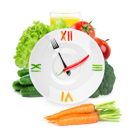 Clock with healthy diet food. Diet concept