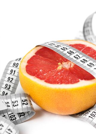 Measuring tape with grapefruit. Diet conceptの写真素材