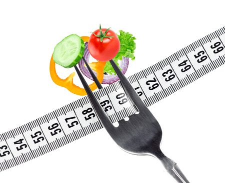 Fresh vegetables on fork. Diet conceptの写真素材