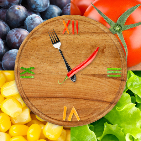 Food clock with vegetables and fruits. Food concept backgroundの写真素材