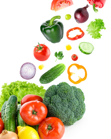 Falling fresh vegetables on white backgroundの写真素材