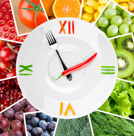 Food clock with vegetables and fruits. Healthy food conceptの写真素材