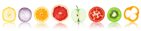 Collection of fresh fruit and vegetable slices on white backgroundの写真素材