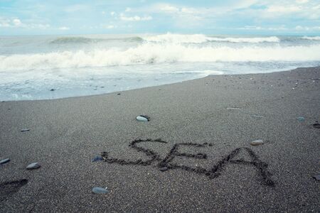 Sea word written on the sandの写真素材