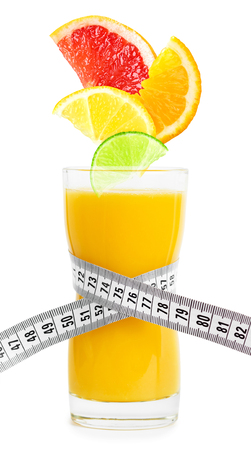 Fresh citrus juice and slices of fruit on white background. Diet conceptの写真素材