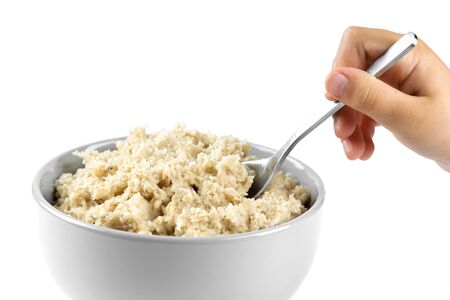 Bowl of porridge on white background. Healthy breakfastの写真素材