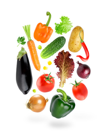 Falling fresh color vegetables on white backgroundの写真素材
