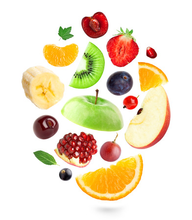 Falling fresh fruits and berries on white backgroundの写真素材